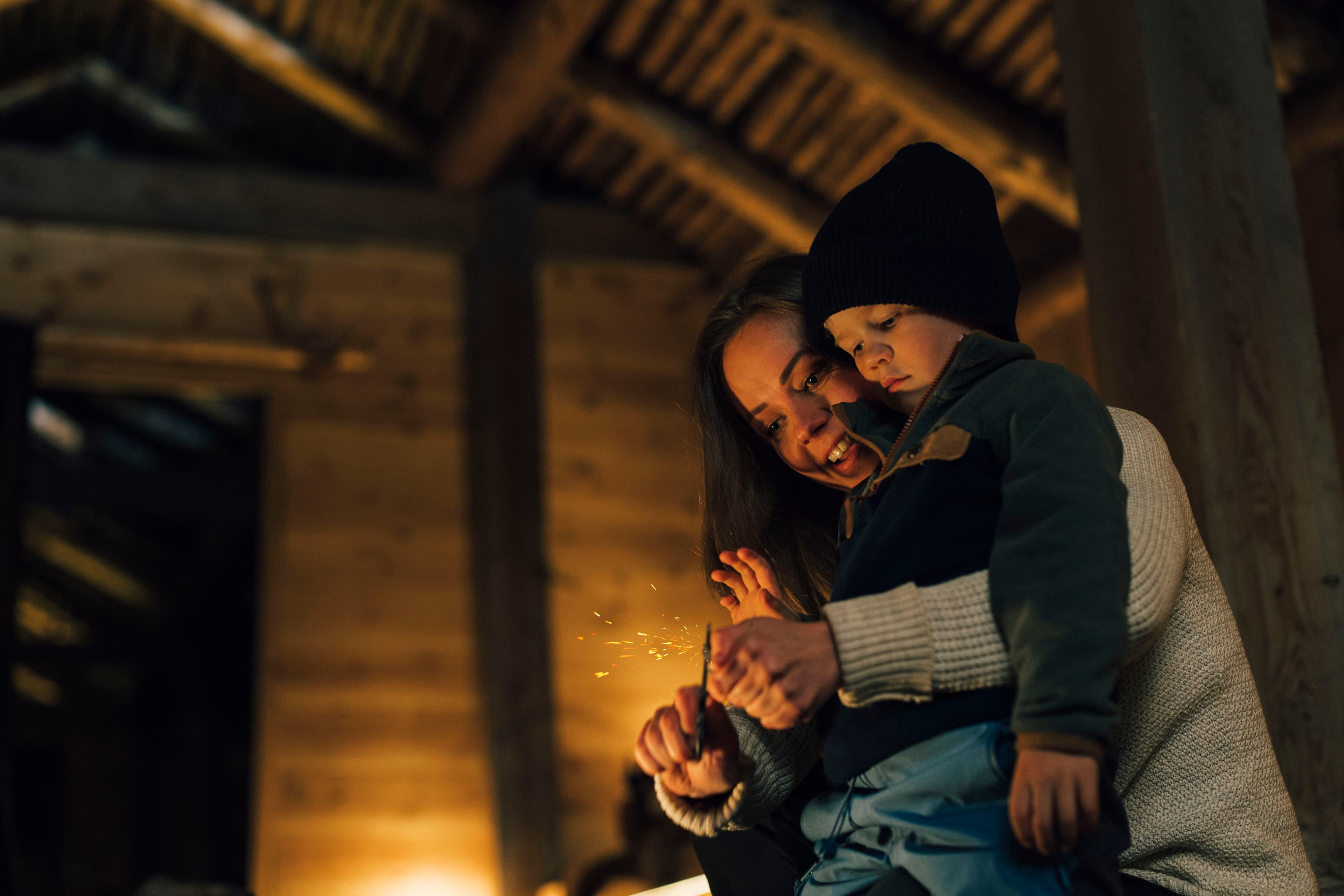 Mum and boy at the Iron Age Farm making fire the old way