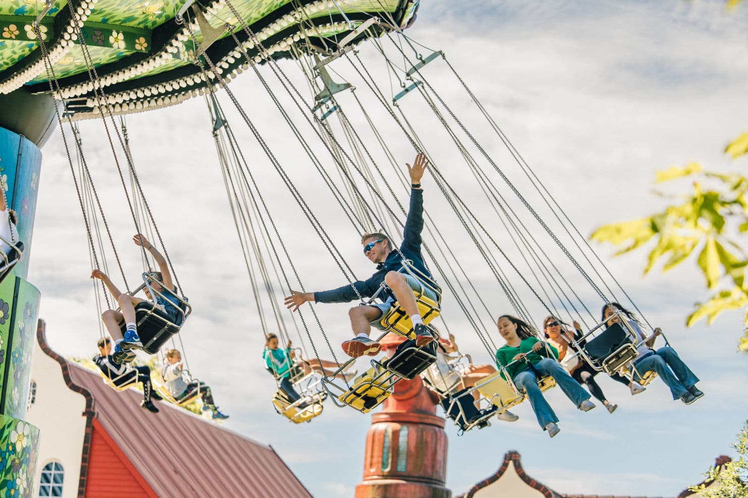 family enjoying themselves in different rides at an amusement park