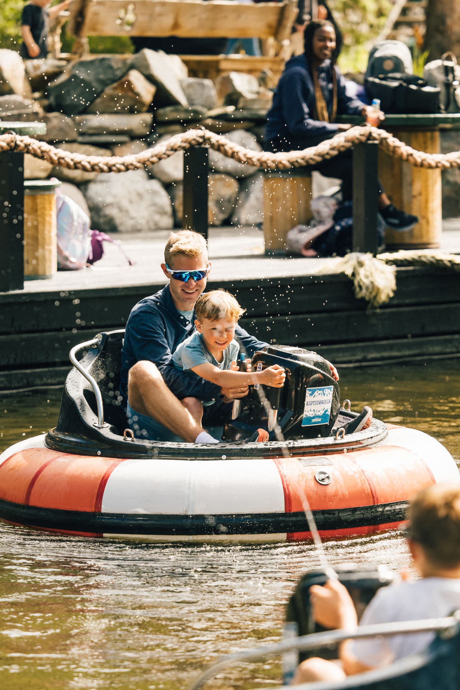 family enjoying themselves in different rides at an amusement park