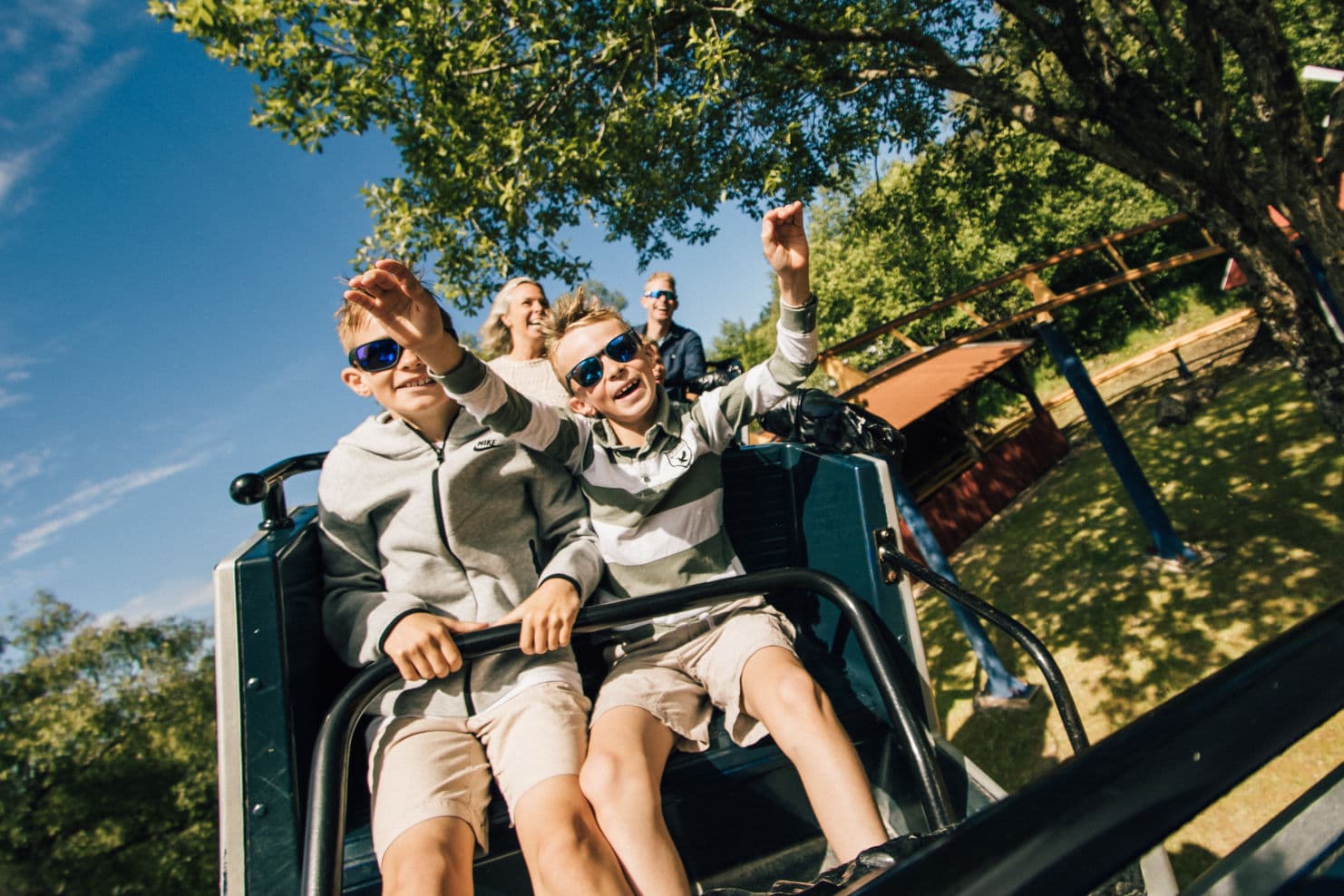 family enjoying themselves in different rides at an amusement park