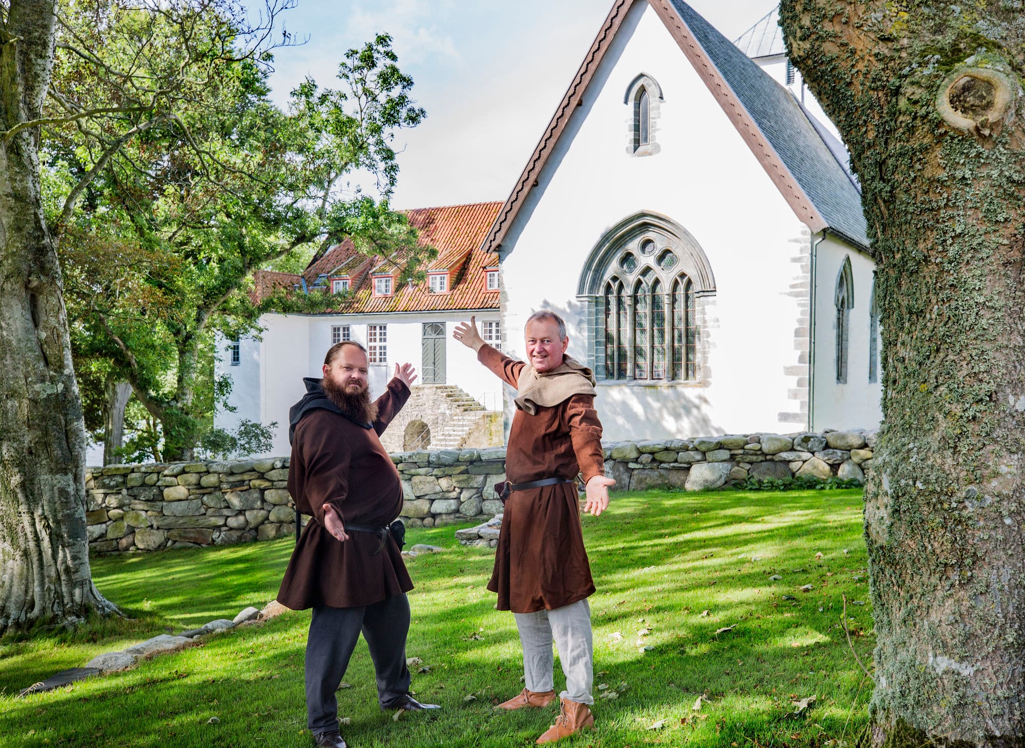 Utstein Kloster/Monastery with two hosts dressed in munk outfits in the monastery gardens