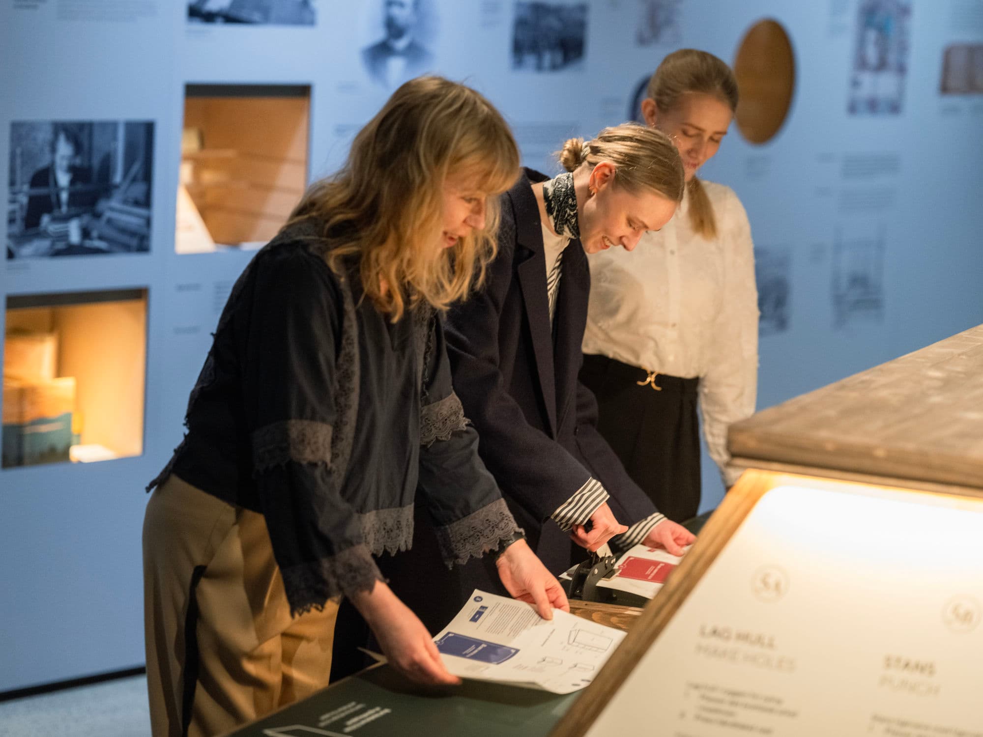 Visitors to a museum looking at exhibition on books and printing